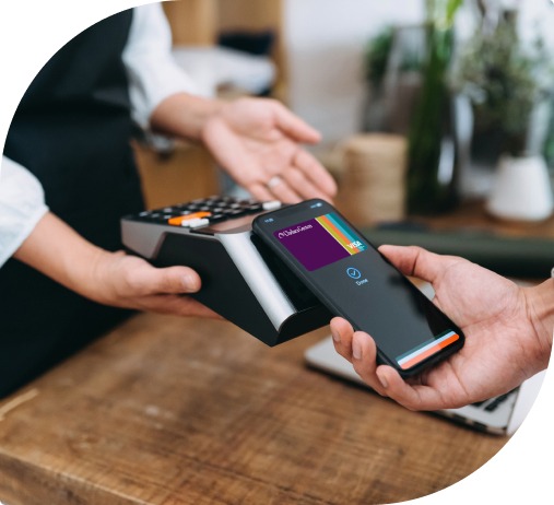 A man taps his Nebula Trust visa debit card in the mobile wallet to pay